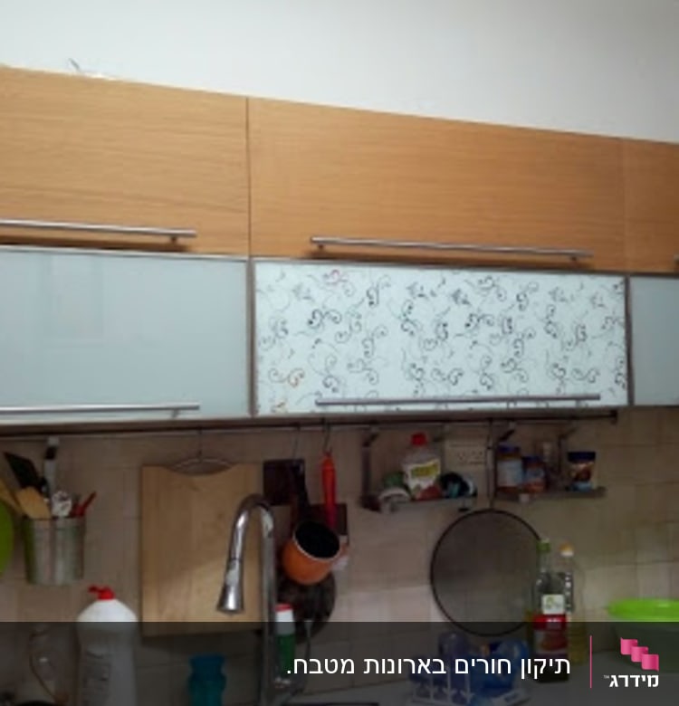 kitchen cabinets with utensils and sink